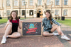 Girls Sitting While Holding A Blackboard Mock-Up Psd