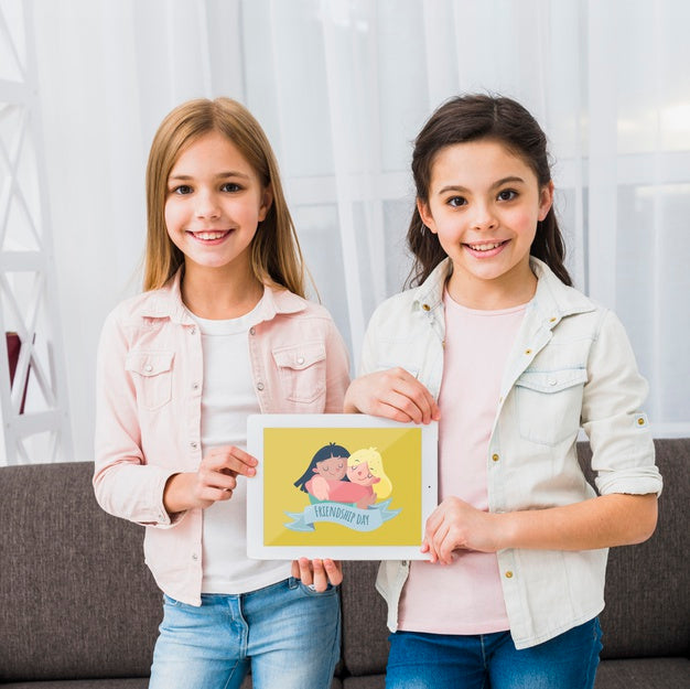Girls Standing And Holding A Tablet Mock-Up Psd