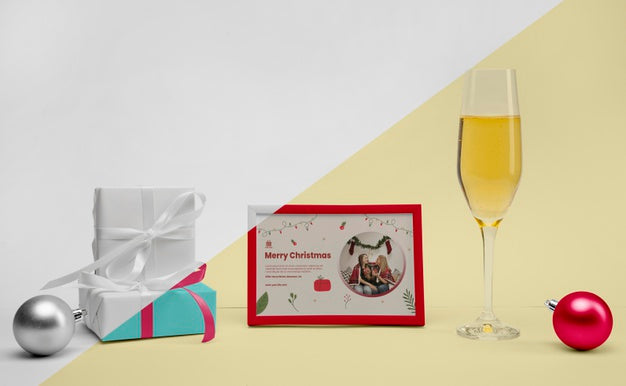 Glass Of Champagne Next To A Frame With Mock-Up Psd