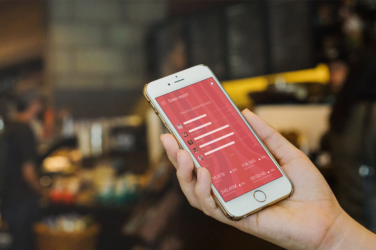 Gold iPhone 7 Mockup in a Hand With Blurred Background