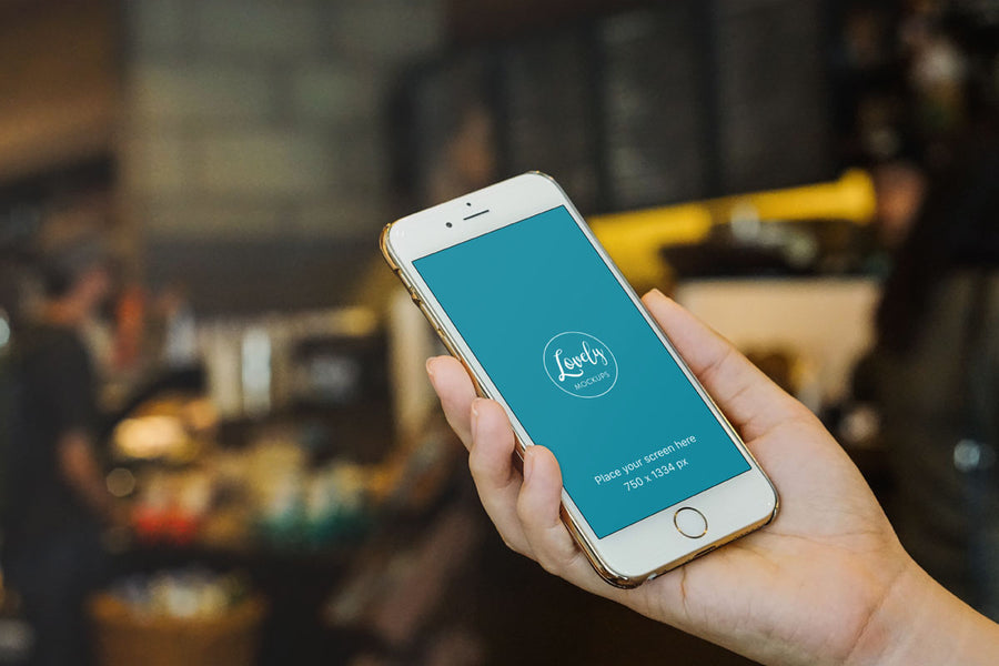 Gold iPhone 7 Mockup in a Hand With Blurred Background