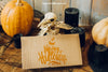 Halloween Mockup With Cardboard And Bird Skeleton Psd
