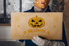 Halloween Mockup With Man Holding Cardboard Psd