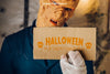 Halloween Mockup With Zombie Holding Cardboard Psd