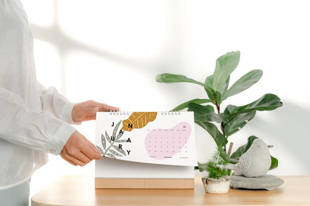 Hand Holding Blank Paper Spiral Calendar Mockup Psd