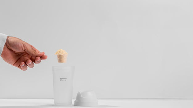 Hand Holding Fitness Spoon Filled With Protein Above Shaker Copy Space Psd