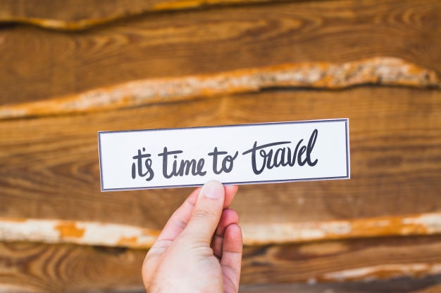 Hand Holding Paper In Nature For Travel Concept Psd