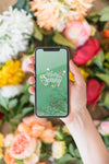 Hand Holding Smartphone Mockup Above Flowers Psd