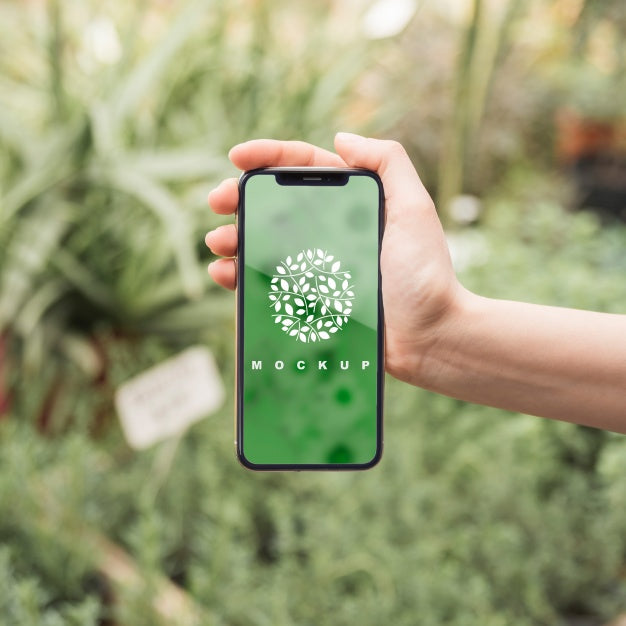 Hand Holding Smartphone Mockup With Gardening Concept Psd