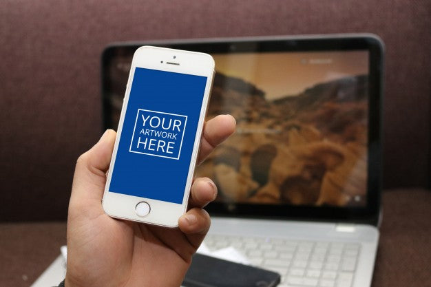 Hand Holding Smartphone With Laptop Behind Psd