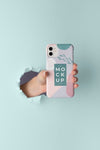 Hand Holding Smartphone With Mock-Up Phone Case Through Wall Tear Psd