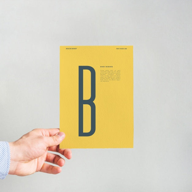 Hand Holding Yellow Paper Mockup Psd