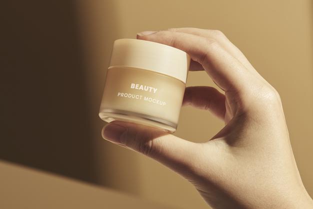 Hand With Small Beige Cream Pot Mockup Psd