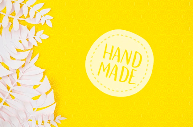 Handmade Badge With White Leaves On Yellow Background Psd