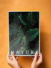 Hands Holding A Nature Magazine On A Orange Background Psd