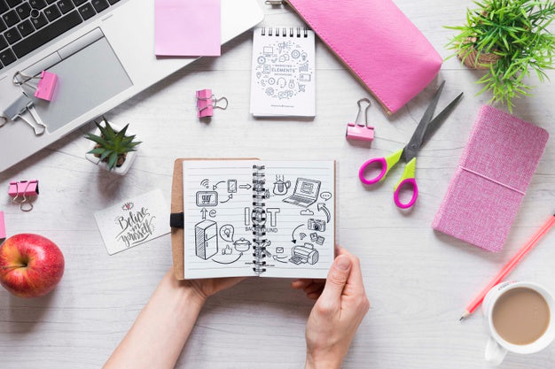 Hands Holding A Notebook On Business Desk Psd