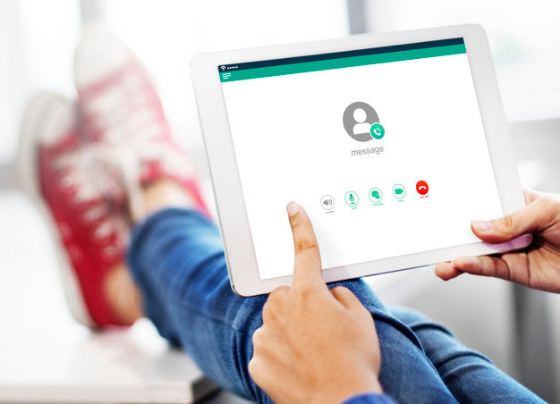 Hands Using A Mockup Tablet With Feet Up In The Background Psd