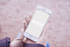 Hands With Gloves Holding A Smartphone Mock Up Psd