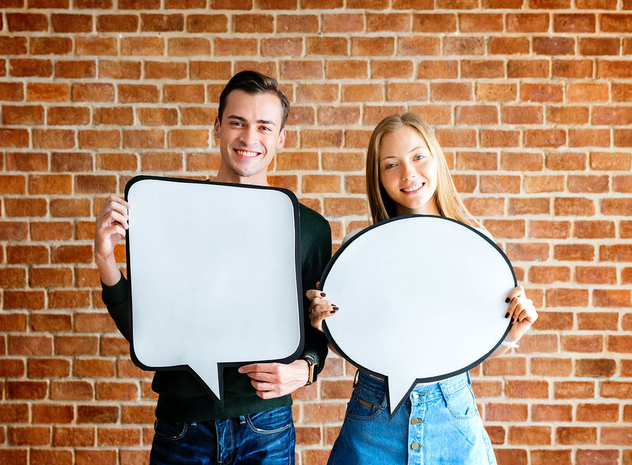 Happy Cute Young Couple Holding An Empty Placard Thought Bubble Copyspace