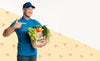 Happy Delivery Man Holding A Box With Different Vegetables With Copy Space Psd