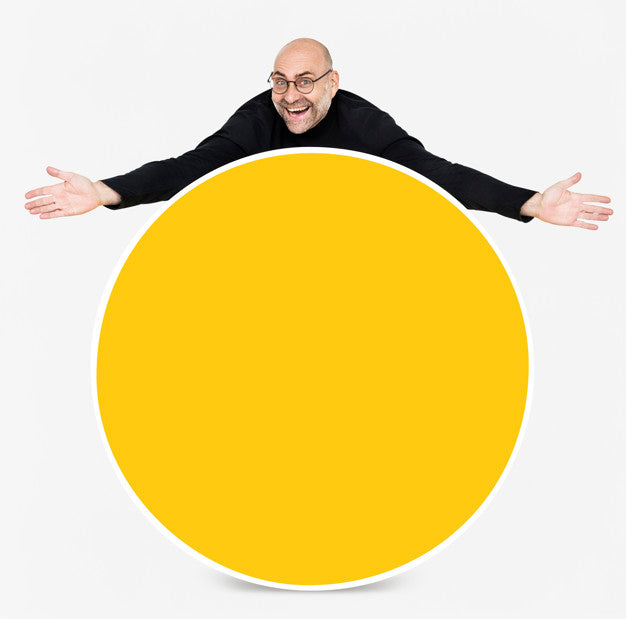 Happy Man Showing A Round Yellow Board Psd