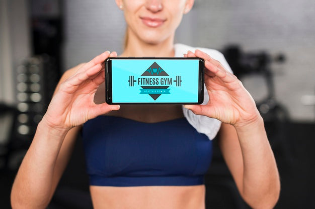 Happy Sporty Woman Presenting Smartphone Mockup Psd