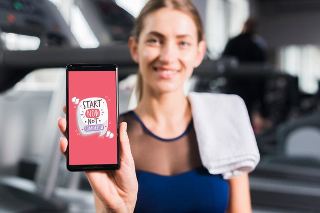 Happy Sporty Woman Presenting Smartphone Mockup Psd