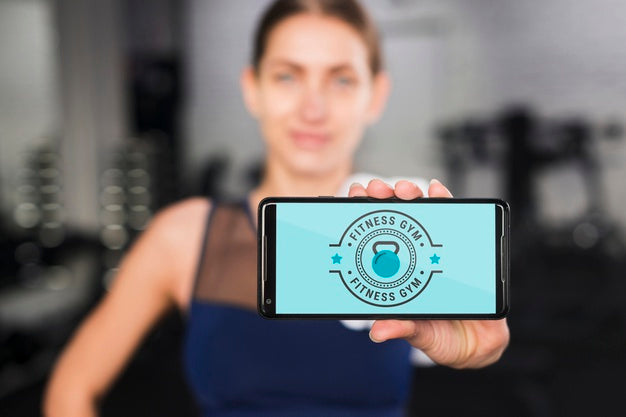 Happy Sporty Woman Presenting Smartphone Mockup Psd