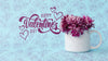 Happy Valentines Day Lettering Next To Cup With Flowers Psd