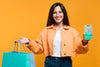 Happy Woman Holding Shopping Bags And A Phone Mock-Up Psd