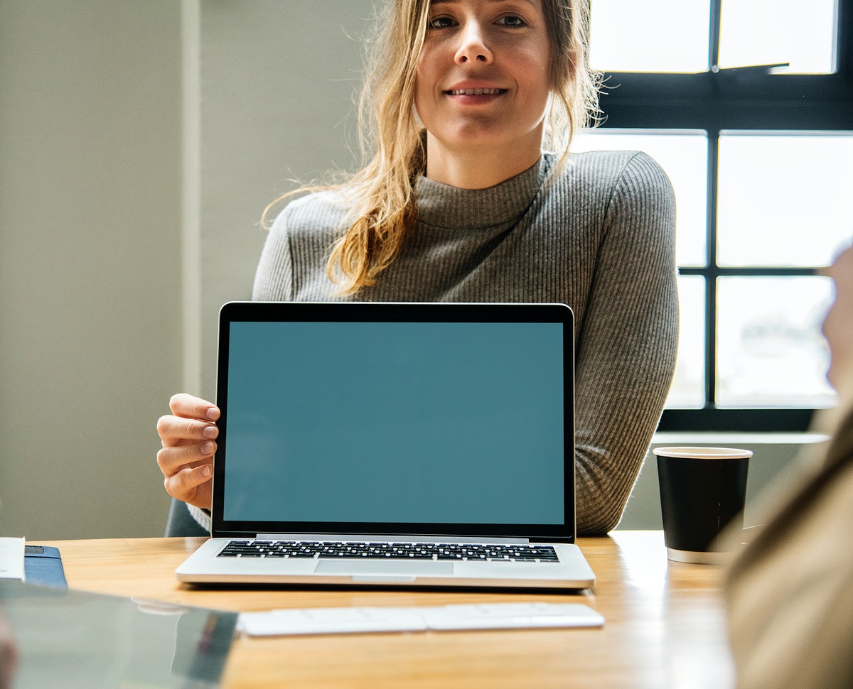 Happy Woman With A Blank Laptop Screen