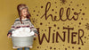 Hello Winter Text And Boy With A Bucket Full Of Snowballs Psd