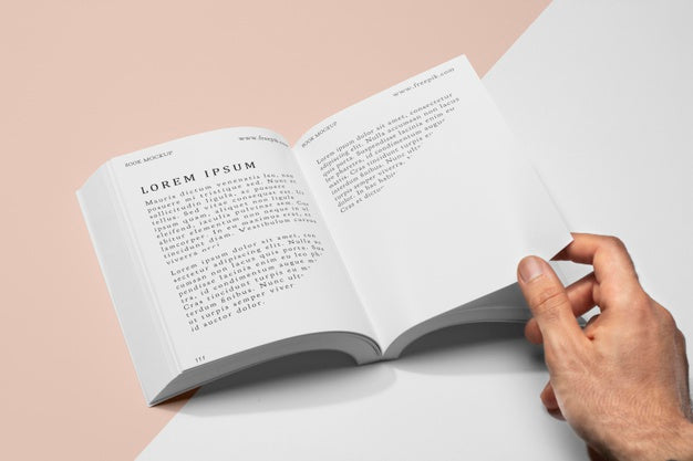 High Angle Hand Holding Page Of Open Book Mock-Up Psd