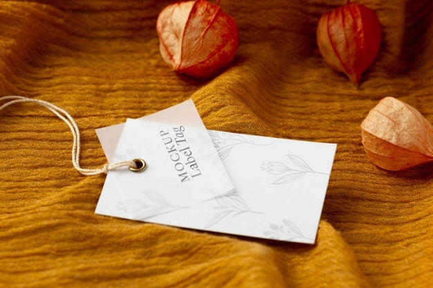 High Angle Of Clothing Label Mock-Up On Orange Textile Psd