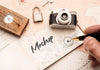 High Angle Of Person Writing On Paper With Camera And Compass For Traveling Psd