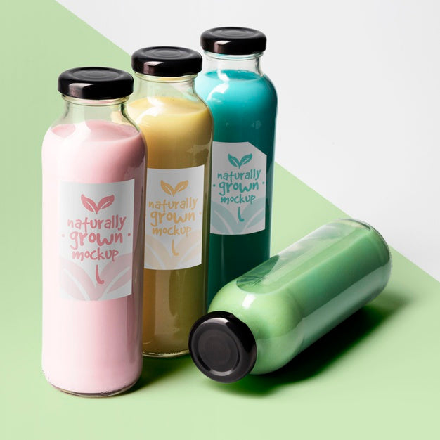 High Angle Of Selection Of Clear Juice Bottles With Caps Psd