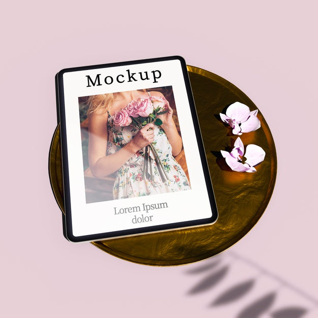 High Angle Of Tablet On Golden Tray With Flowers Psd
