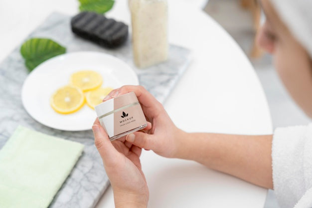 High Angle Of Woman Holding Bottle Of Cosmetic Cream Psd