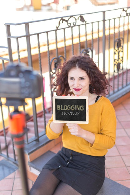 High View Woman Holding Blogger Mock-Up Psd