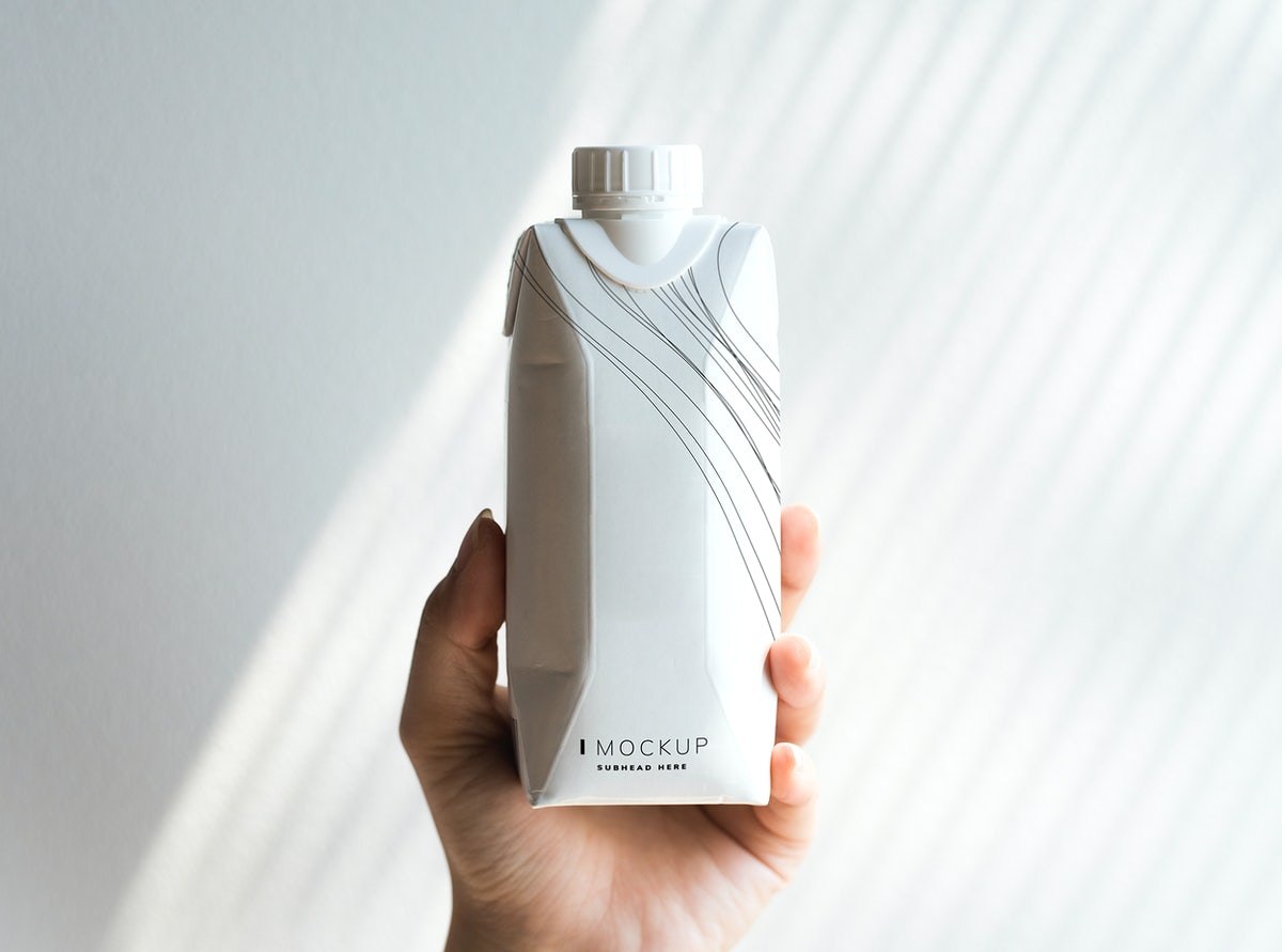 Human Hand Holding Paper Bottle Mockup