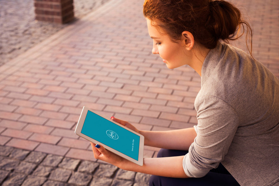 Woman Holding or Watching an iPad Mockup