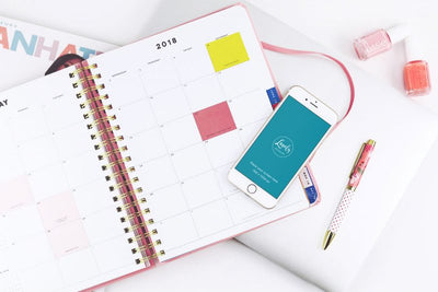 iPhone Mockup With A Calendar On A Table