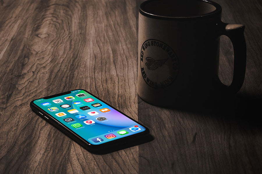 iPhone X with Coffee Mug Mockup