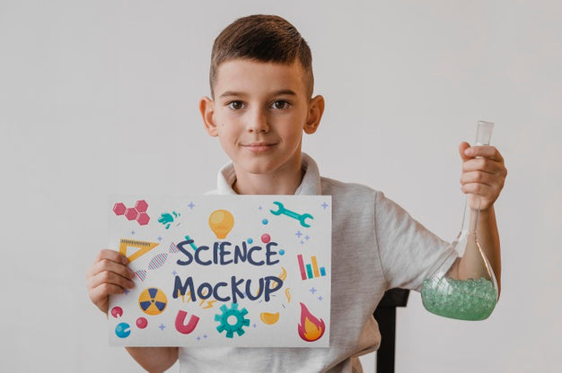 Kid Holding A Card Mock-Up While Learning Science Psd