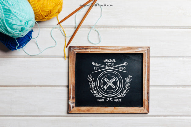 Knitting Concept With Slate And Sticks Psd