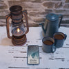 Lantern And Kettle With Hot Tea Beside Mobile Psd