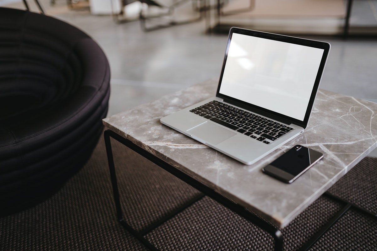 Laptop And A Phone On A Marble Table