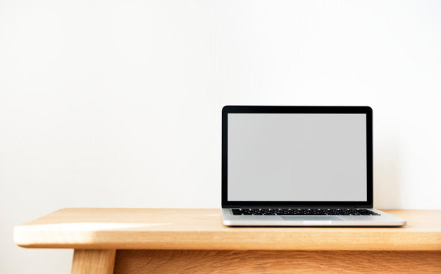 Laptop On A Wooden Table Psd