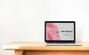 Laptop Showing Website Template On A Wooden Table Psd
