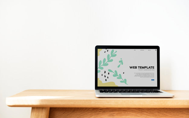 Laptop Showing Website Template On A Wooden Table Psd